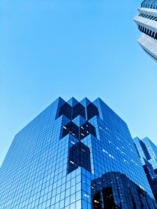 Upward view of office building in urban setting. Photo by Omar Flores via unsplash.com